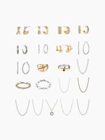 A flat-lay grid display of the necklace assortment included in the kit, featuring various gold and silver chain styles, pendants, and bracelets arranged vertically.