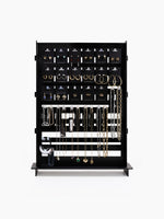 The black wooden jewelry display rack fully stocked with earrings, necklaces, and bracelets from the Cosmo $199 Starting Kit, shown on a plain white background.