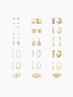 A flat-lay grid display of the earring assortment included in the kit, showing pairs of gold and silver earrings (studs, hoops, and drops) arranged neatly.