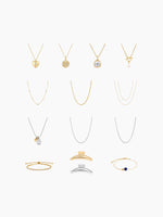 A flat-lay grid display of the necklace assortment included in the kit, featuring various gold and silver chain styles, pendants, and bracelets arranged vertically.