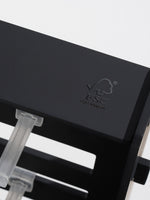 A close-up of the black wooden base and a clear acrylic hook attached to the horizontal slats.