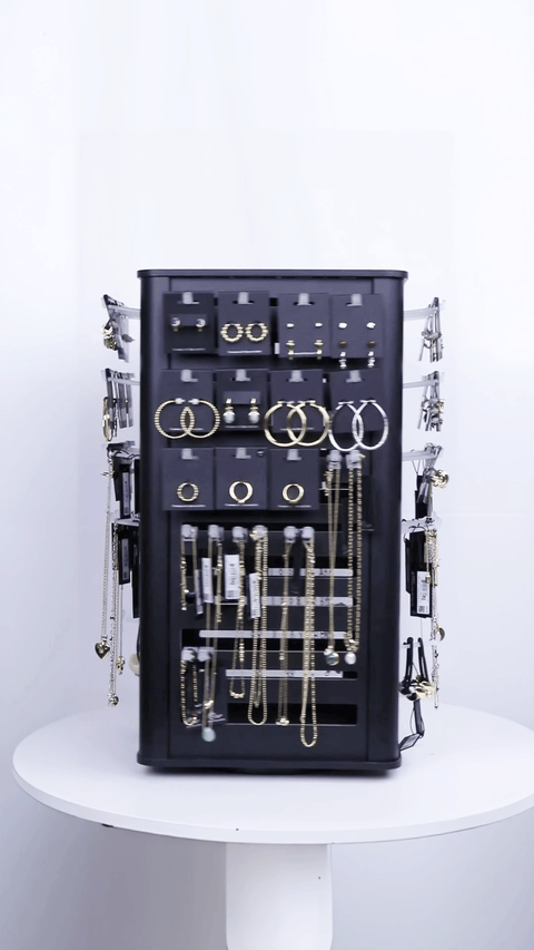 Rotating 4-sided black wood jewelry display racks GIF, spinning showcase demonstrating hanging earrings and necklaces, wholesale organizer.
