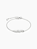 A silver chain bracelet featuring a central cluster of round and marquise-cut cubic zirconia stones, with an adjustable sliding bead and lobster clasp, displayed on a plain white background.