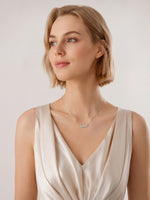 Close-up of a model's neck showcasing a delicate silver multi-stone necklace. Lightweight sparkle for bridal, layering, or casual office looks.