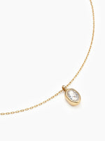 A close-up angled view of the oval cubic zirconia pendant on its gold chain, focusing on the sparkling stone and bezel setting.